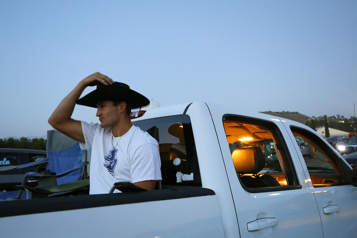 Graduate Cameron Ewert, a cowboy at heart, waits for his class' graduation ceremony to start.  He's hoping for a career as a firefighter. 