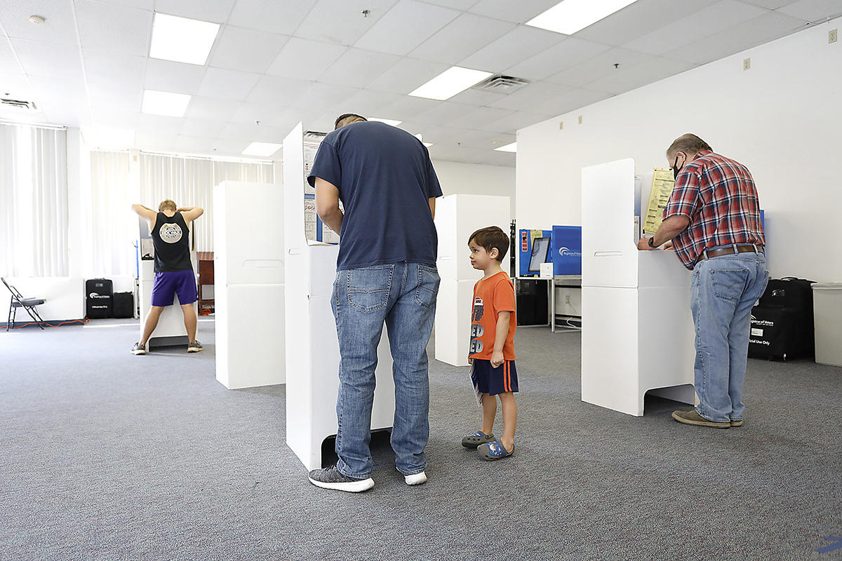 Little Nicky Ruiz Jr. watched his father Nick Ruiz, Sr. cast his vote on election day where turnouts set records.  : Year in Pictures 2020 : Corporate and Event Photographer