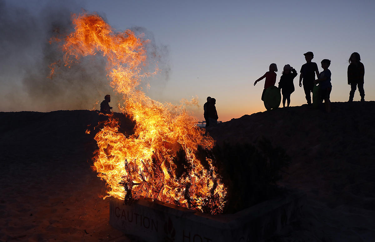 Four days into the new year a family watched their Christmas tree incinerate on the beach, nobody imagining the year we would enter.  : Year in Pictures 2020 : Corporate and Event Photographer