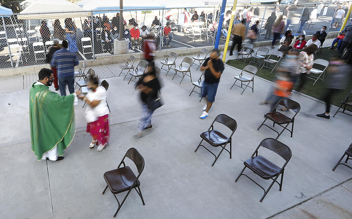 In September Father Edmundo Zárate gave out communion to his socially distanced flock at St. Jude Shrine of the West as COVID deaths topped 200,000 nationally. : Year in Pictures 2020 : Corporate and Event Photographer